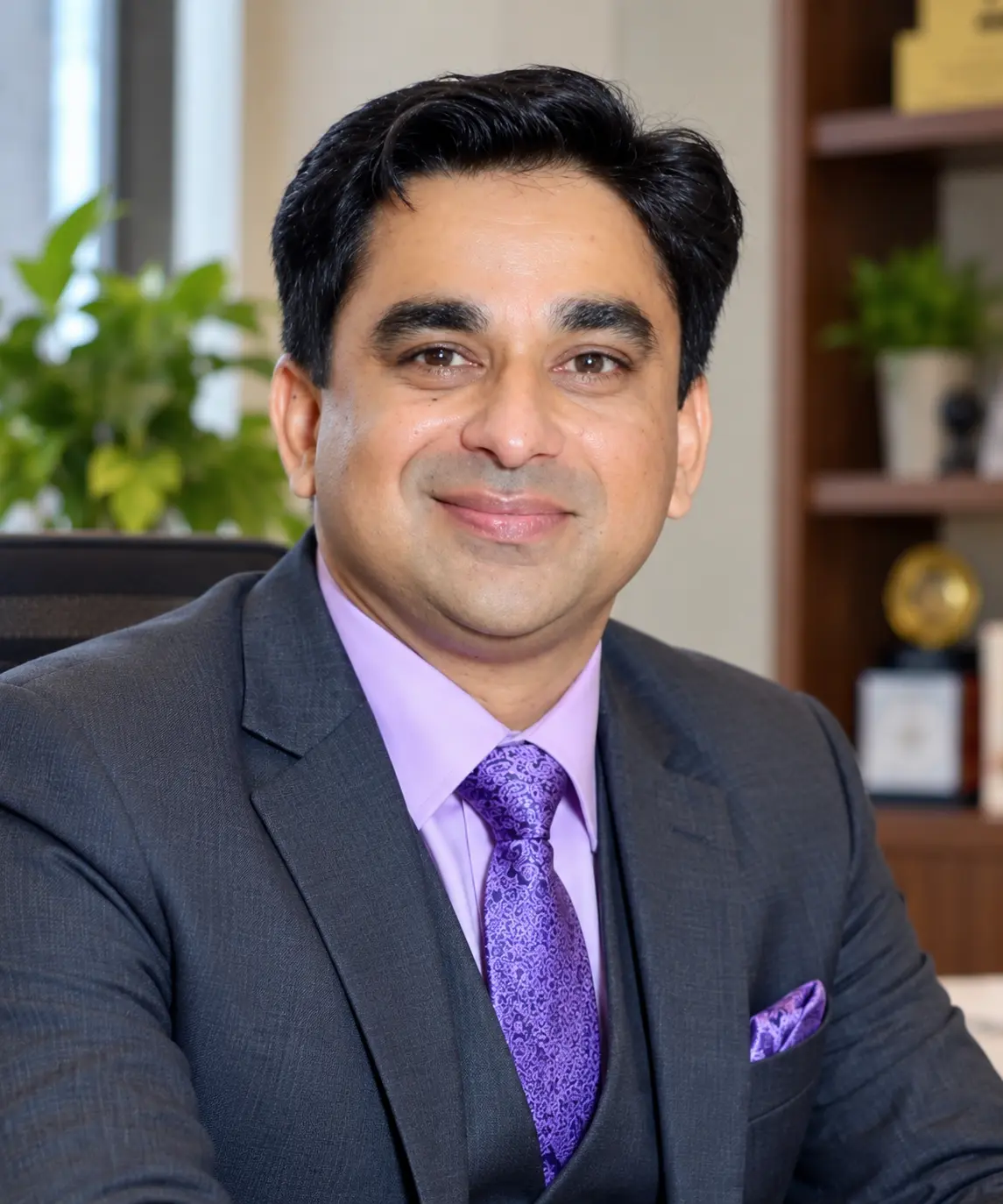 Our Story Professional portrait of Pankaj Thakur, Creative Partner at Zelora Naturals, wearing a formal suit in an office setting.
