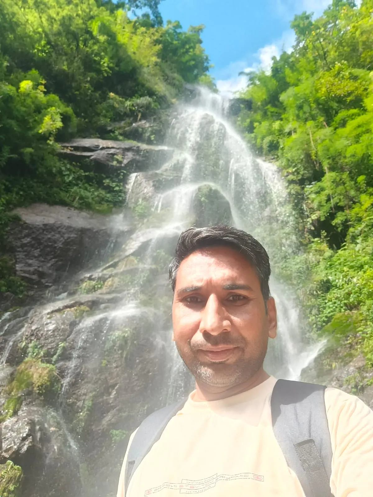 Home Raj Kumar, Sales Manager at Samsung from Barnala, Punjab, standing in front of a scenic waterfall.
